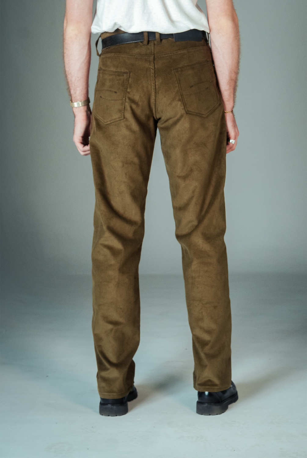 Brown pants worn by a person on a plain background