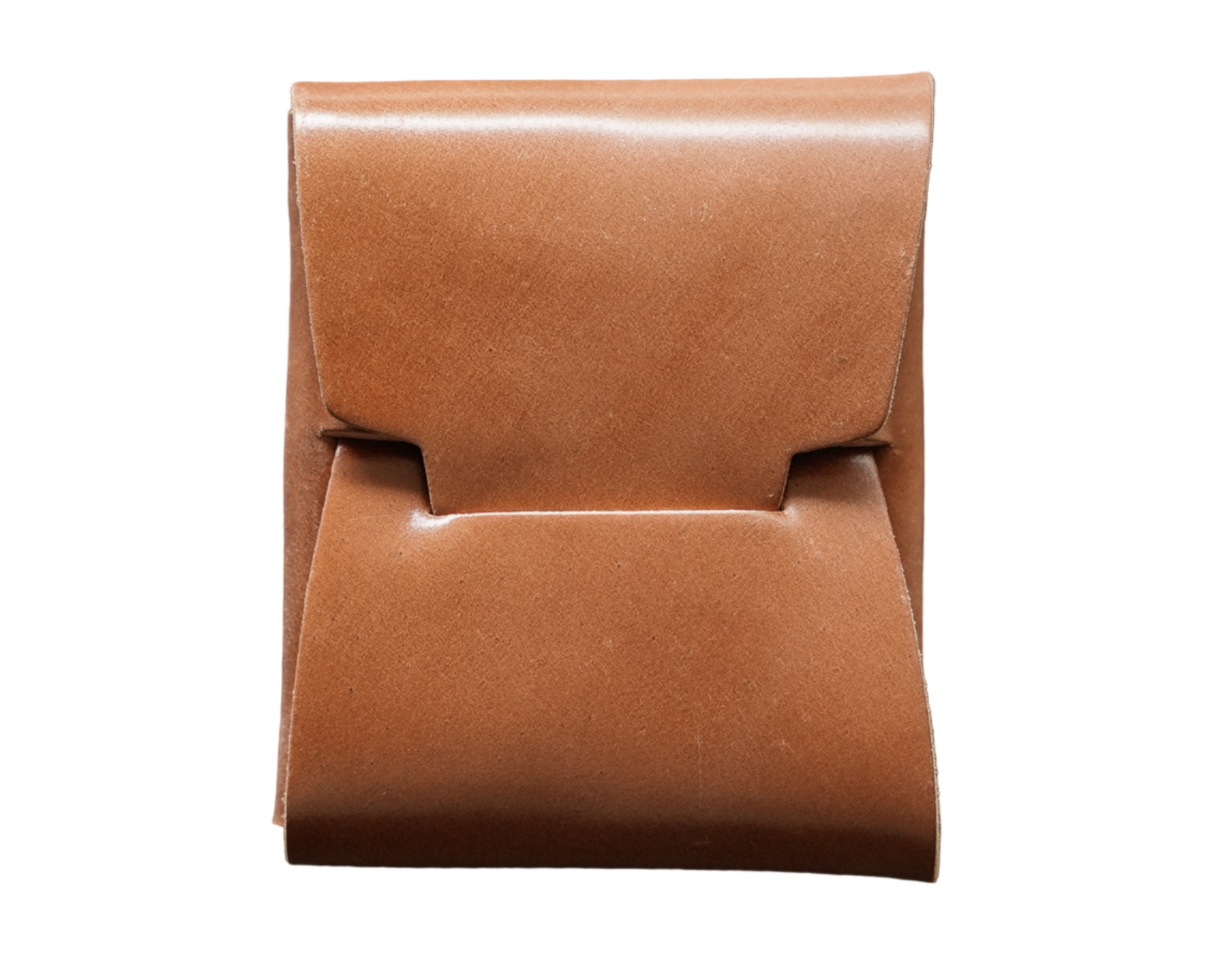 A brown leather wallet with a fold-over front, placed on a textured metal surface.