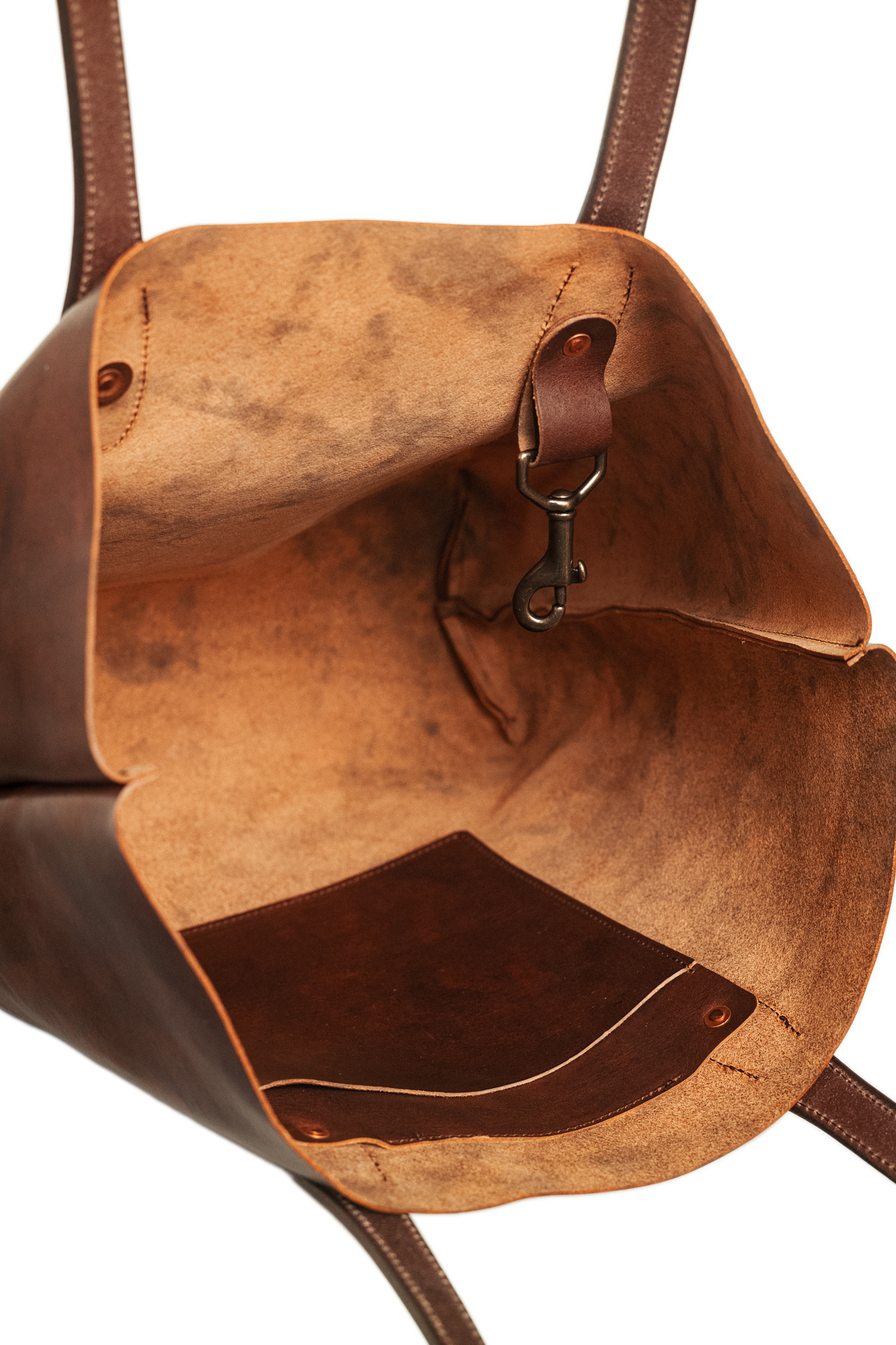 Brown leather bag with a reflective surface on a white background